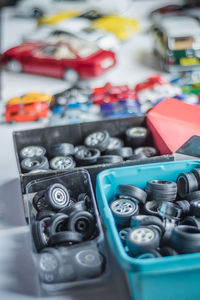 High angle view of toy tires in containers on table