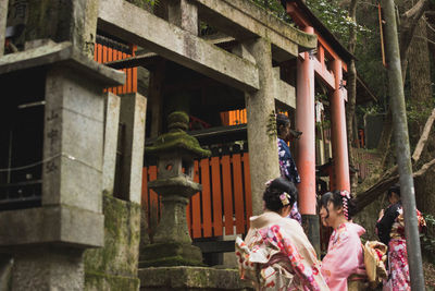 People outside temple against building
