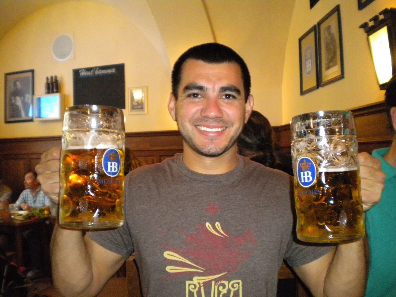 food and drink, indoors, drink, lifestyles, young men, refreshment, leisure activity, person, communication, front view, holding, freshness, portrait, looking at camera, table, restaurant, drinking glass, close-up