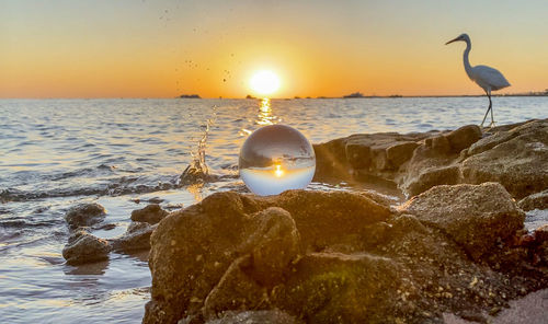 Scenic view of sea against sky during sunset