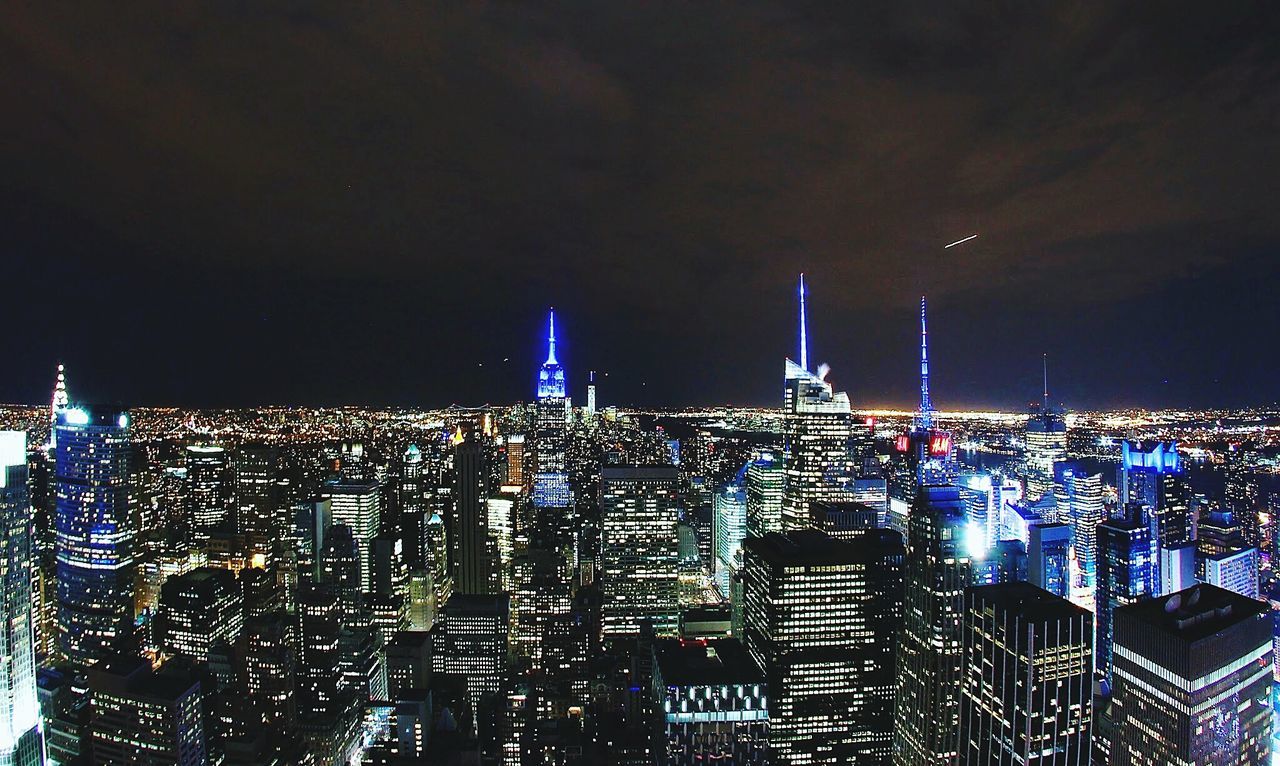 AERIAL VIEW OF ILLUMINATED CITY AT NIGHT