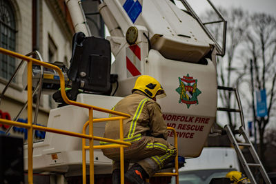 Rear view of man standing in bus