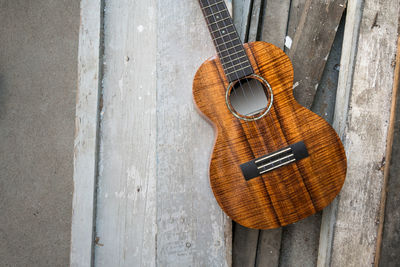 Close-up of guitar on wooden table