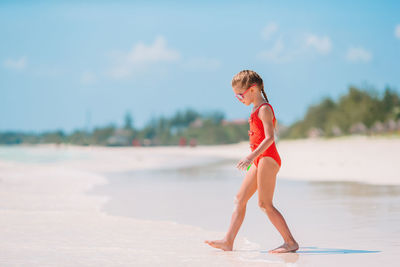 Side view of woman walking on beach