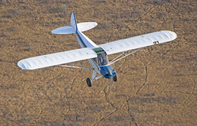 High angle view of airplane flying over land