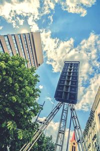 Low angle view of buildings against cloudy sky