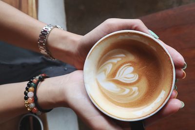 Midsection of woman coffee cup