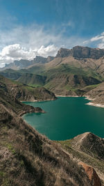 Scenic view of lake and mountains against sky