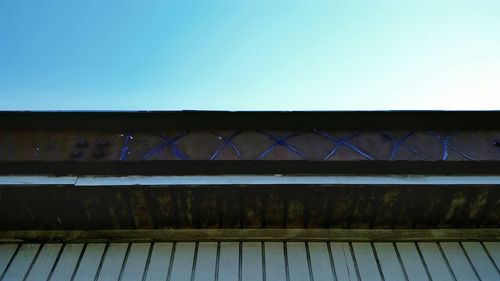 Low angle view of bridge against clear blue sky