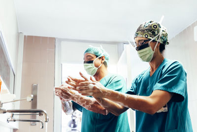 Midsection of couple standing in kitchen