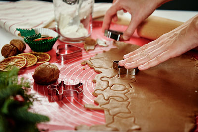 Process of woman making gingerbread cookies at home