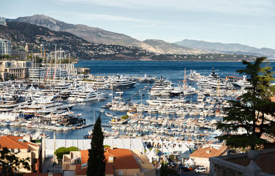 High angle view of townscape by sea against sky