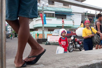 Low section of woman standing on street