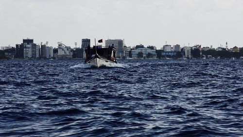 Sea and cityscape against sky