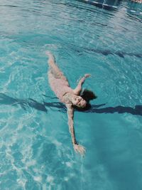 High angle view of woman swimming in pool