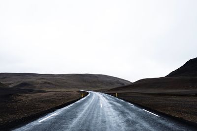 Empty road against clear sky