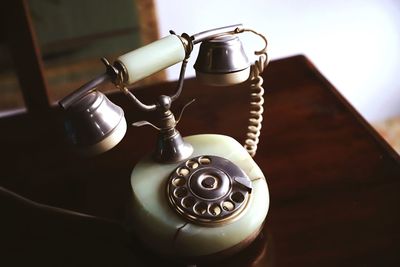 Close-up of old telephone on table