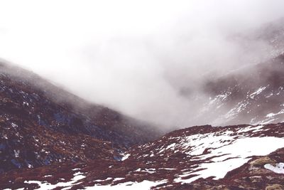 Scenic view of mountains during foggy weather