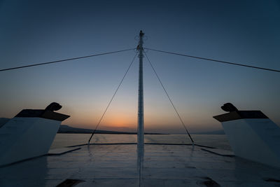 Silhouette ship on sea against clear sky during sunset