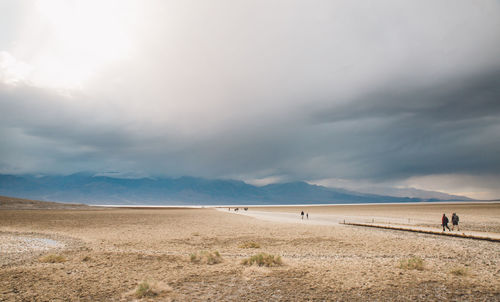 Scenic view of sand dunes against sky