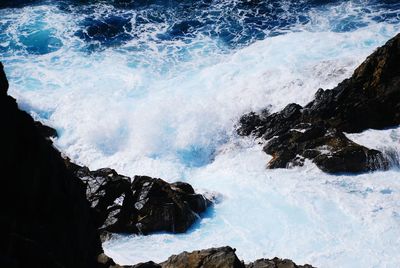 High angle view of waves flowing at sea