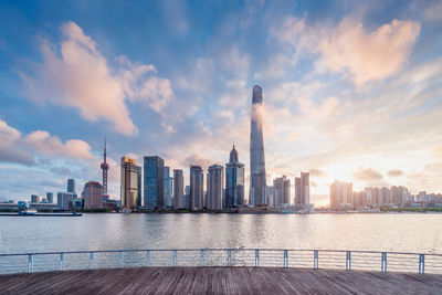 View of cityscape against cloudy sky