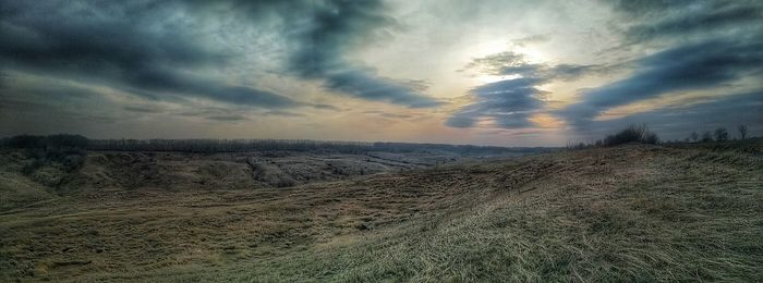 Scenic view of land against sky during sunset