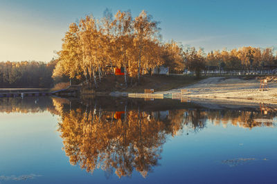 Reflection of trees in lake against sky during autumn