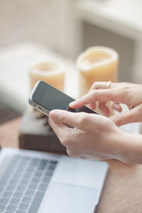 Midsection of man using mobile phone