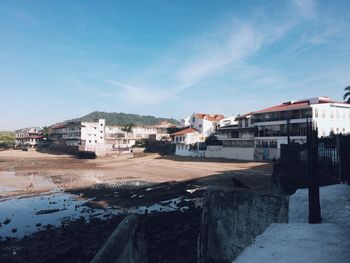 Buildings in town against sky