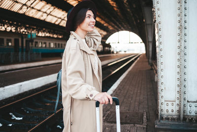 Pretty smiling woman at the railway station