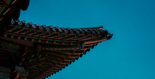 Low angle view of temple against clear blue sky