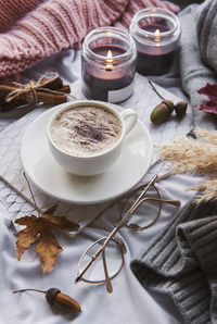 Autumn still life with pumpkins, coffee and burning candles. cozy fall composition