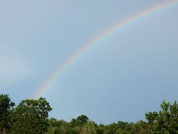 Low angle view of rainbow against clear blue sky