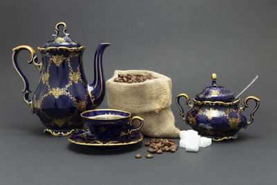 Close-up of tea served on table against black background