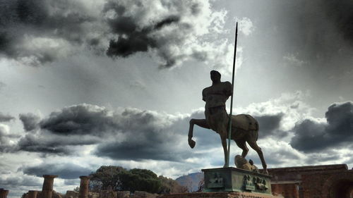 Low angle view of statue against cloudy sky