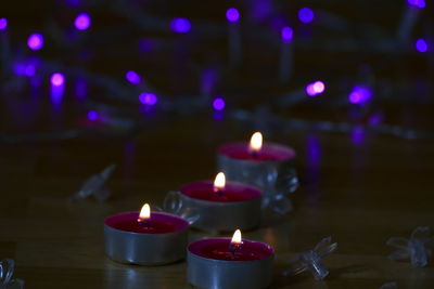 Close-up of lit candles on table