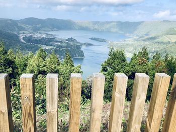 Panoramic view of wooden post and plants against sky