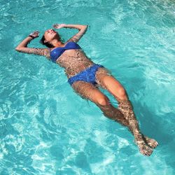 Woman floating on water in pool