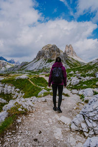 Rear view of woman on mountain against sky