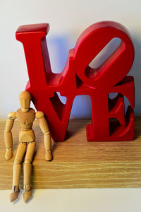 Close-up of toys on table against white background