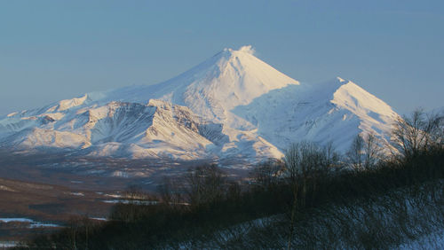 Scenic view of snowcapped mountains against clear sky