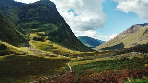 Scenic view of mountains against cloudy sky