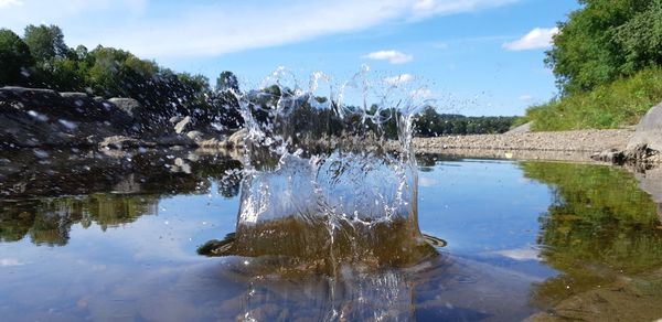Scenic view of lake against cloudy sky