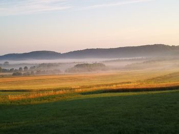 Scenic view of field against sky during sunset