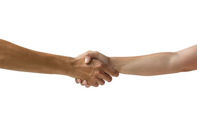 Midsection of couple holding hands against white background