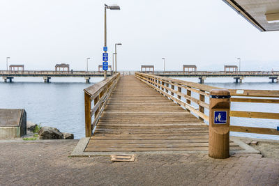 View of pier over sea against clear sky