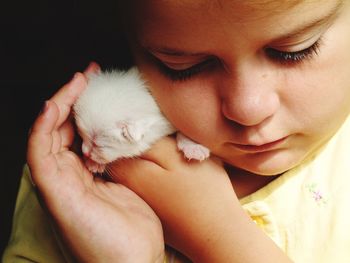 Close-up of cute girl with kitten