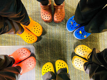 Low section of people standing on tiled floor