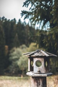 Close-up of old birdhouse on field